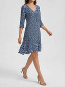 Bella navy blue abstract scatter print A-line mini dress with ruffled hem, angled front view
