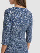 Bella navy blue printed mini dress with white abstract scatter print, back view on white background