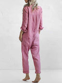 Pink linen-cotton jumpsuit with rolled sleeves and cuffs, back view on a white background.