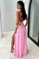 Pink maxi dress with open back, side slit, and tie waist, angled view.