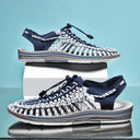 Navy and white woven sandals with adjustable heel straps and cushioned soles, shown in side-by-side views.
