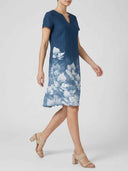 Charlotte Floral Midi Dress in navy blue worn by a model walking, showing short sleeves, split V-neck and full-length botanical border print.
