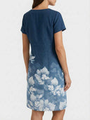 Charlotte Floral V-Neck Midi Dress in navy blue, back view showing clean A-line cut and white botanical floral lower-half print.