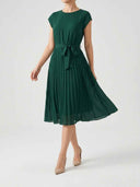 Clara dark green pleated midi dress with cap sleeves and self-tie bow belt, three-quarter front view — midi wedding guest dress for garden parties and christenings.