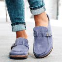 Lilac suede-look closed-toe platform mules with adjustable buckle strap and cork flatform sole, front angled view.