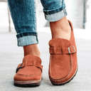Brown suede-look closed-toe platform mules with adjustable buckle strap and cushioned flatform sole, front angled view.