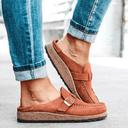 Brown closed-toe platform mule with adjustable buckle strap and cushioned flatform sole, side view.
