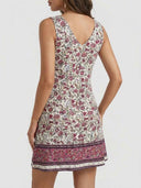 Cleo floral mini dress back view showing V-neck back detail and contrasting deep berry paisley border hem on A-line skirt.