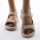 Coral cushioned arch support sandals with dual adjustable straps, shown from front and side view on white background.