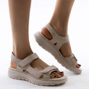 Coral cushioned arch support sandals with adjustable straps and thick sole, angled side view.