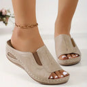 Open toe wedge mule sandals with cushioned footbed and contrast stitching detail, angled front view on feet.