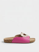 Rose red heart cutout flatform slide sandal with white heart detail on wide strap and cork-effect footbed, side view on white background.