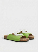 Pair of light green heart cutout flatform slide sandals with cork-effect footbed, angled view on white background.