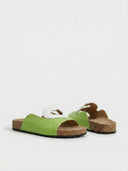 Pair of light green flatform mule sandals with white heart cutout detail, angled product view on white background.