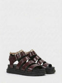 Wine red platform sandals with multi-strap upper and gold chain ankle detail, angled view on white background.