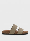 Khaki two-strap flat slide sandals with wide straps and cork-look footbed, angled view on white background.