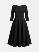 Daisy black A-line midi wedding guest dress with bateau neckline, three-quarter sleeves and rhinestone jewelled waist belt, front view.