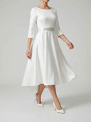 Daisy white satin-touch A-line midi dress with rhinestone belt and three-quarter sleeves, angled front view showing full skirt volume.