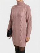 Daisy pink cable-knit turtleneck mini sweater dress with long sleeves, styled with black knee-high boots and a black chain-strap clutch, angled front view.
