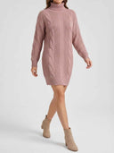Daisy pink cable-knit turtleneck mini sweater dress with long sleeves styled with knee-high black boots, full-body view.