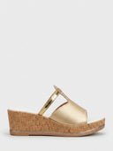 Gold wedge mule sandal with tan platform sole and cushioned white footbed lining, side view.