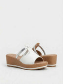 White platform wedge mule sandals with silver strap detail, angled front view on white background.