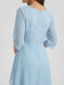 Daisy sky blue midi dress showing floral embroidered back detail and sheer 3/4-sleeve jacket, angled back view.