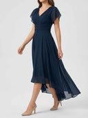 Daisy navy V-neck flutter sleeve midi dress showing high-low asymmetric hem and fluid A-line skirt, angled view.