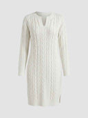 White cable-knit long sleeve mini dress with split notch neckline, front view on light grey background.