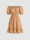Daisy off-shoulder smocked floral mini dress in golden-yellow floral print, tiered ruffle hem and smocked waistband, front view on white background.