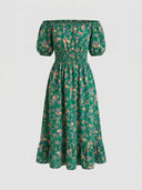 Daisy off-shoulder smocked floral mini dress in Green, A-line skirt with tiered ruffle hem and smocked bardot bodice, front view on white background.