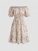Daisy off-shoulder smocked floral mini dress in Khaki, ditsy floral print with pink flowers, short puff sleeves and elasticated bardot neckline, front view on white background.