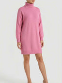 Pink oversized turtleneck ribbed knit mini dress with long sleeves, angled front view on model.