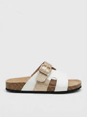 White and champagne gold double-strap leather flat slide sandal with cork footbed, side view.