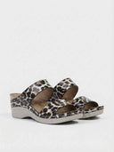 Leopard print wedge sandals with two wide straps and grey wedge sole, angled three-quarter view.
