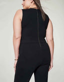 Black sleeveless jumpsuit with full-length back zipper, shown from the back on a light background.
