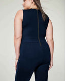 Navy blue sleeveless jumpsuit with back zipper, shown from the back on a light background.