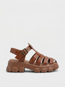 Brown crocodile-embossed cage flatform sandal with chunky lug sole, side view showing platform height.