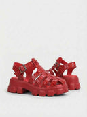Red crocodile-embossed cage flatform sandal with silver buckle closure and chunky sole, angled view on white background.