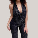 Black sequin halter jumpsuit with deep V-neck and cutout waist, front view on light background.