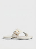 White cross-strap flat slide sandal with gold buckle accent, angled side view on white background.