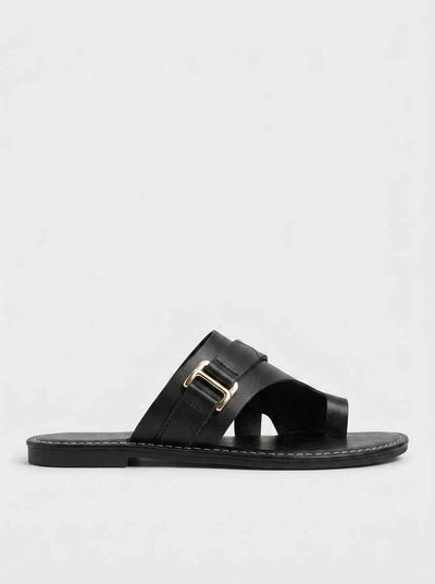 Black cross-strap flat slide sandal with gold-tone rectangular buckle and white contrast stitching, side profile view on white background.