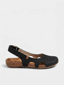 Black closed-toe slingback sandal with scalloped cutout vamp, cork flatform sole, and adjustable velcro strap — side view on white background.