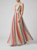 Delilah rainbow stripe A-line maxi dress with plunging V-neck and cinched waist, side-angled view showing full skirt volume.