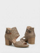 Taupe laser-cut block heel sandal with silver buckle and back zip fastening detail, angled rear-side view.