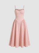 Delilah blush pink sweetheart midi dress with spaghetti straps, boned corset bodice, and full gathered A-line skirt, front view.
