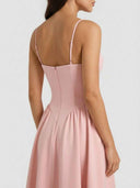 Delilah blush pink sweetheart midi dress showing spaghetti straps, back view with gathered A-line skirt and back zipper closure.