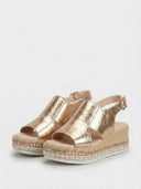 Rose gold metallic espadrille wedge platform sandals showing stud-embellished midsole and jute rope sole detail, angled view.