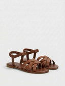 Brown flat sandals with woven multi-strap front and elastic ankle strap, angled three-quarter view.