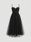 Black spaghetti strap mini dress with ruffled bust and flared tulle skirt, front view.